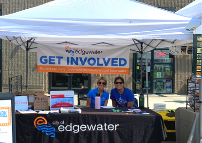 Farmers market booth with volunteers